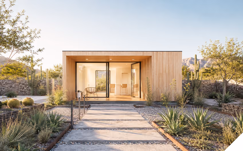 Timber-clad modular house with floor-to-ceiling glass doors
